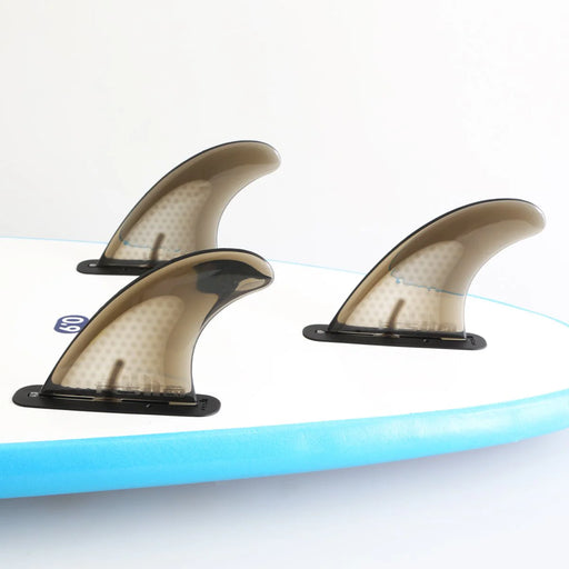 FCS II Safety Tri Fin Set inserted into the bottom if an FCSII equipped soft top surfboard.