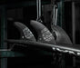 Futures Alpha Vector 3/2 size Large thruster fin set made of black recycled carbon with silver accents  installed in a surfboard