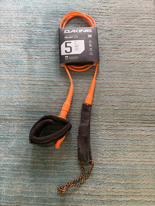 Dakine branded KAIMANA 5' x 3/16" orange & black Surfboard Leash including a urethane cord, a molded neoprene cuff and rail saver.