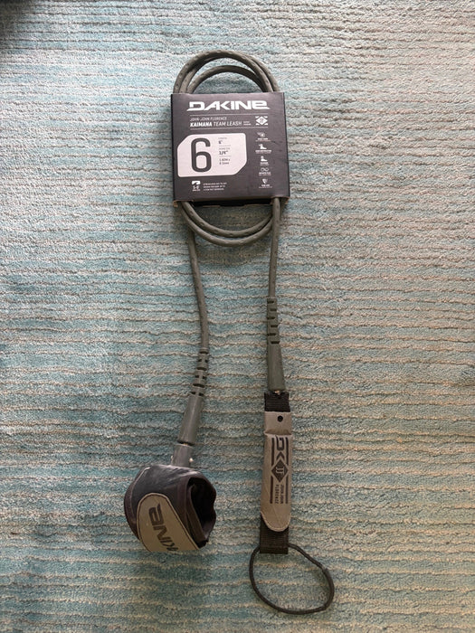 Dakine branded JJF KAIMANA black 6' x 1/4" red Surfboard Leash including a urethane cord, a molded neoprene cuff and rail saver.