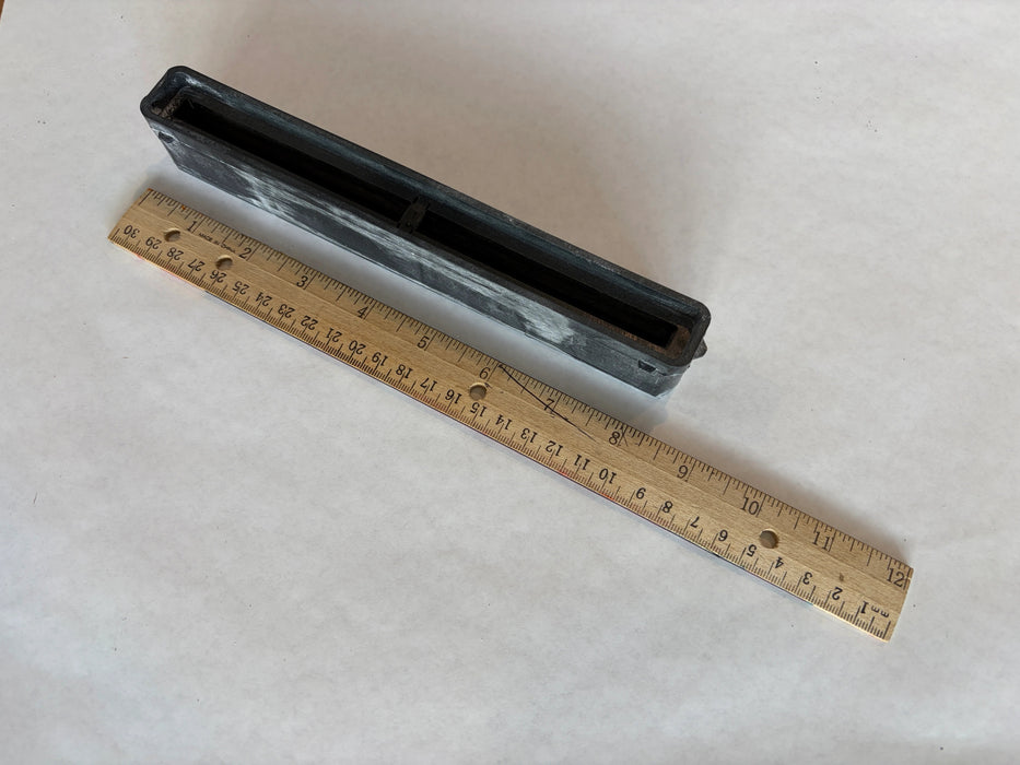 Bahne 8.5" surf channel or center fin box in black side angle view with a ruler to understand the length of this box.