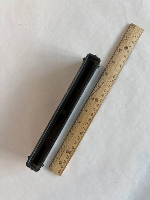 Bahne 8.5" surf channel or center fin box in black top down view with a ruler to understand the length of this box.