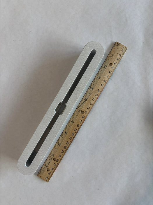 Bahne SUP fin box in white top down view with a ruler to understand the length of this box.