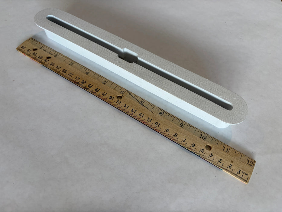 Bahne SUP fin box in white side angle view with a ruler to understand the length of this box.