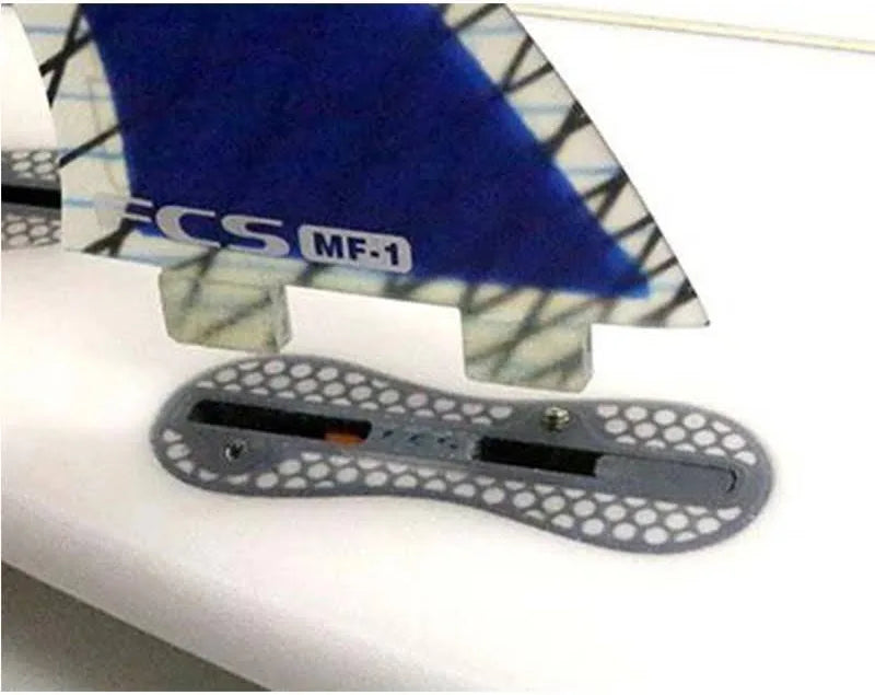 FCS II Side Plug Infill installed in FCSII Fin Box with FCS fin (not included) positioned over the box and set screw installed but visible.