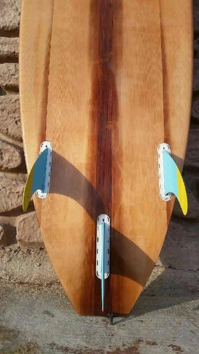 Hollow wood surfboard bottom with thruster Futures fins boxes visible