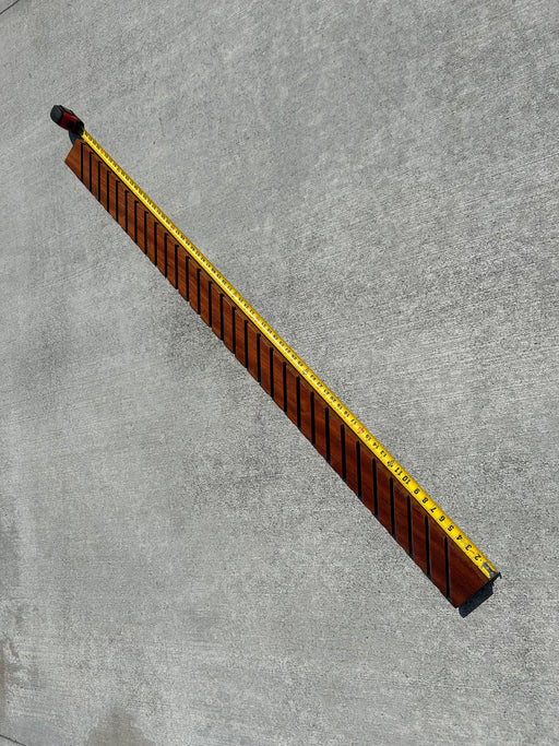 67" long wood with slits to hold many surfboard skegs to display collection