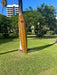 Wood Surfboard in park off Waikiki Beach leaning against a palm tree