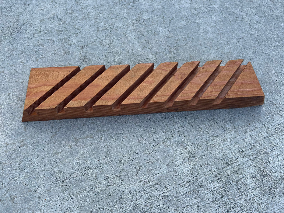 Repurposed wood with grooves to display 8 surfboard fins