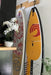 A surfboard and SUP shown hanging using the hang ups hangers in a custom setup.