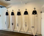 Five surfboards shown on a wall hang ups hangers are show in use.
