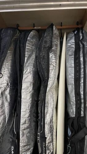 Hang Ups hanger system used to store 4 surfboards stored in their bags a closeup.