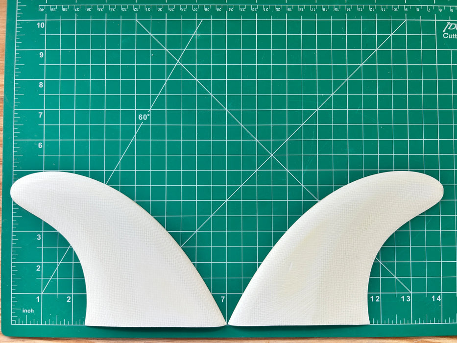 5" White opaque fiberglass used glass on twin fins on a green grid