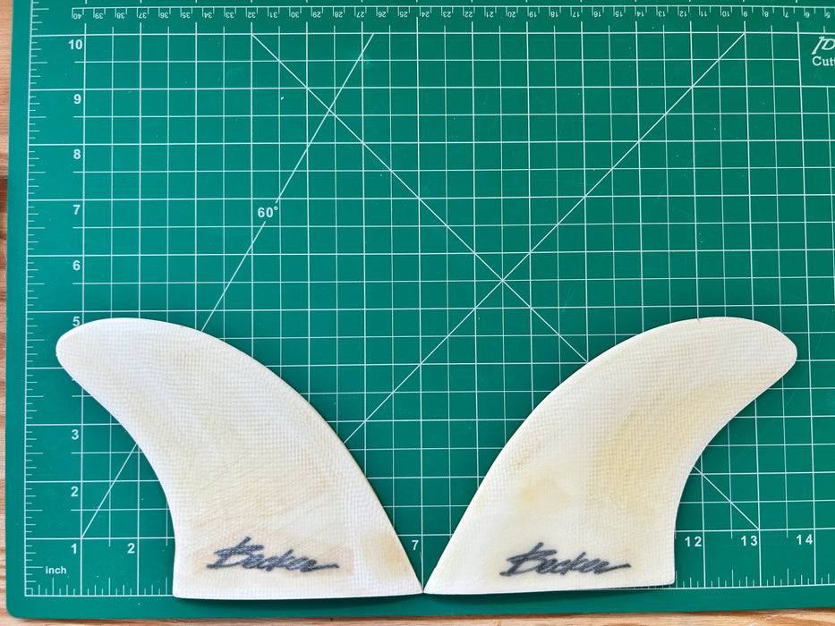 4 3/4" used Becker black opaque fiberglass glass on twin fins, side bites or half a quad set on a green grid 