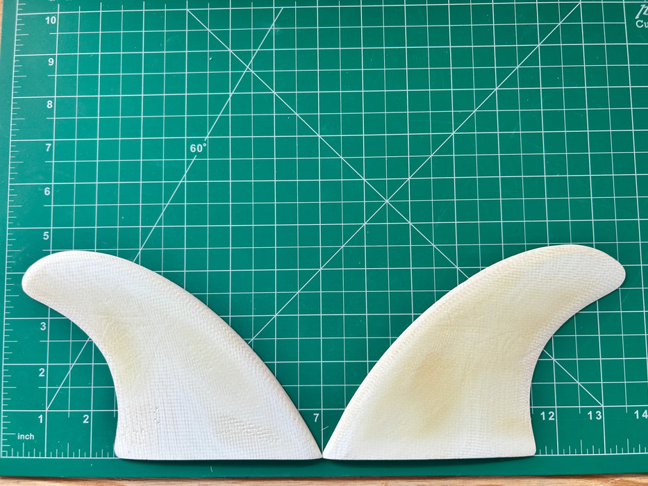 4 1/2" White opaque fiberglass used glass on twin fins on a green grid