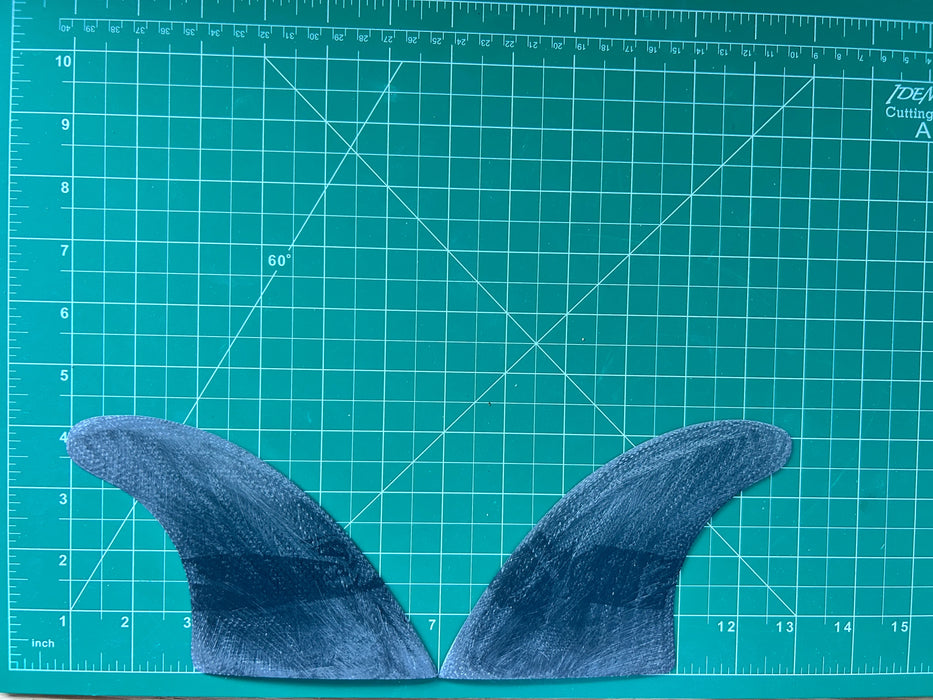 4 1/8" black opaque used fiberglass glass on twin fins, side bites or half a quad set on a green grid 