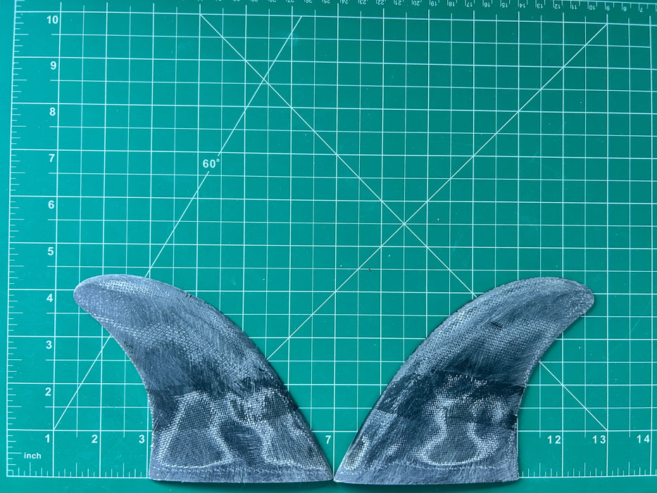 4 3/8" black opaque used fiberglass glass on twin fins, side bites or half a quad set on a green grid 