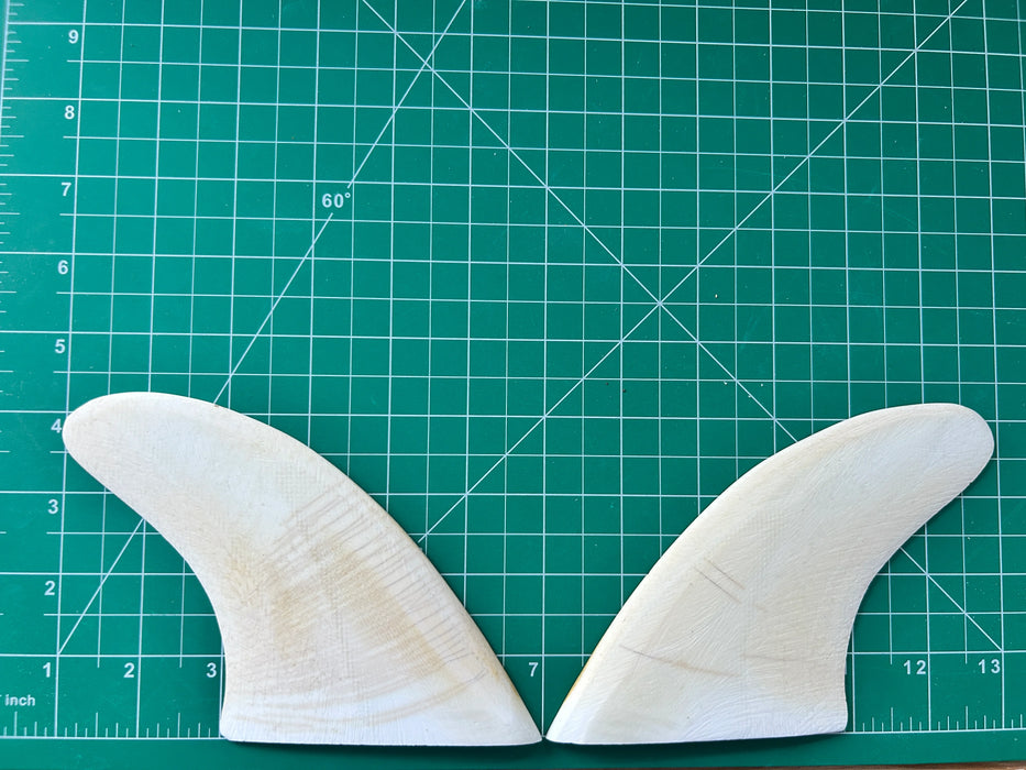 4 1/4" white opaque used fiberglass glass on twin fins, side bites or half a quad set on a green grid 