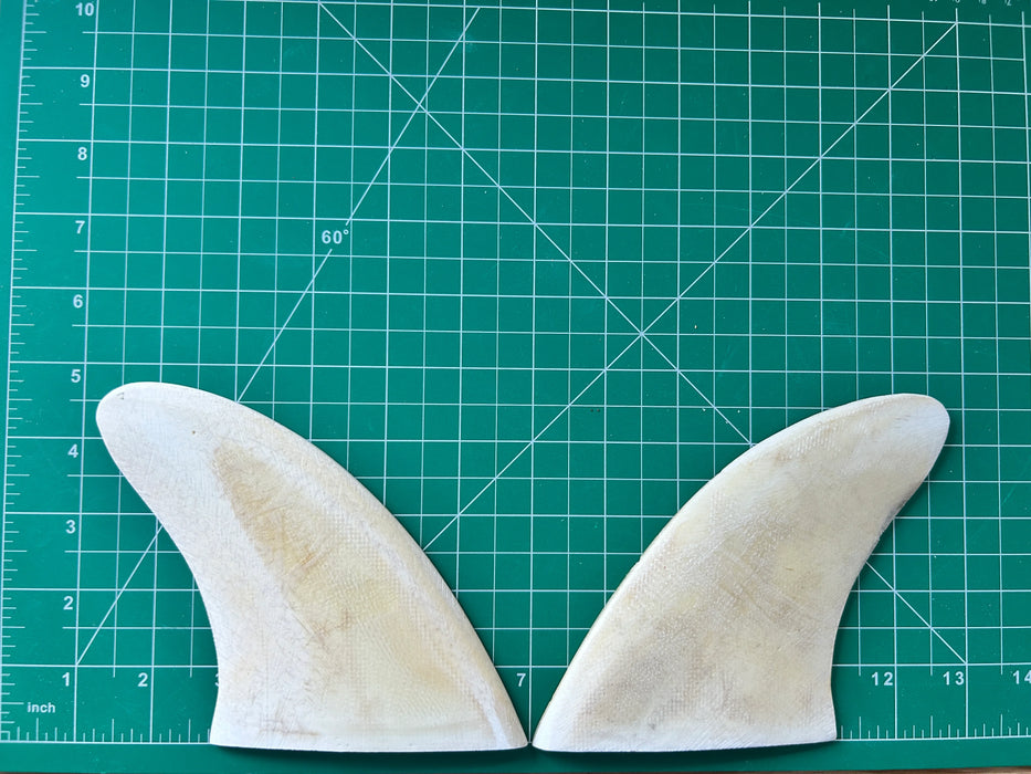 4 3/4" black opaque used fiberglass glass on twin fins, side bites or half a quad set on a green grid 