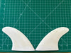 4 3/8" used White opaque fiberglass glass on twin fins, side bites or half a quad set on a green grid 