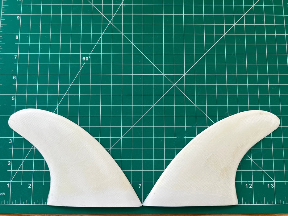4 3/8" used White opaque fiberglass glass on twin fins, side bites or half a quad set on a green grid 