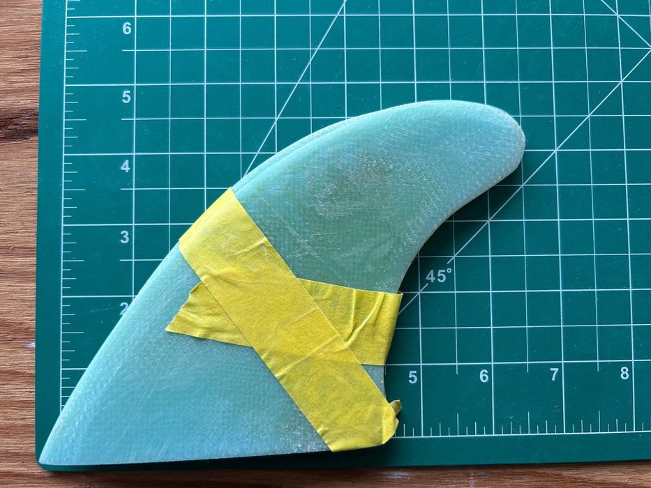 Three translucent teal used glass on fins stacked one on top of each other