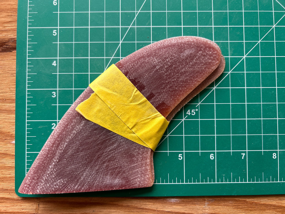 Three translucent red used glass on fins stacked one on top of each other