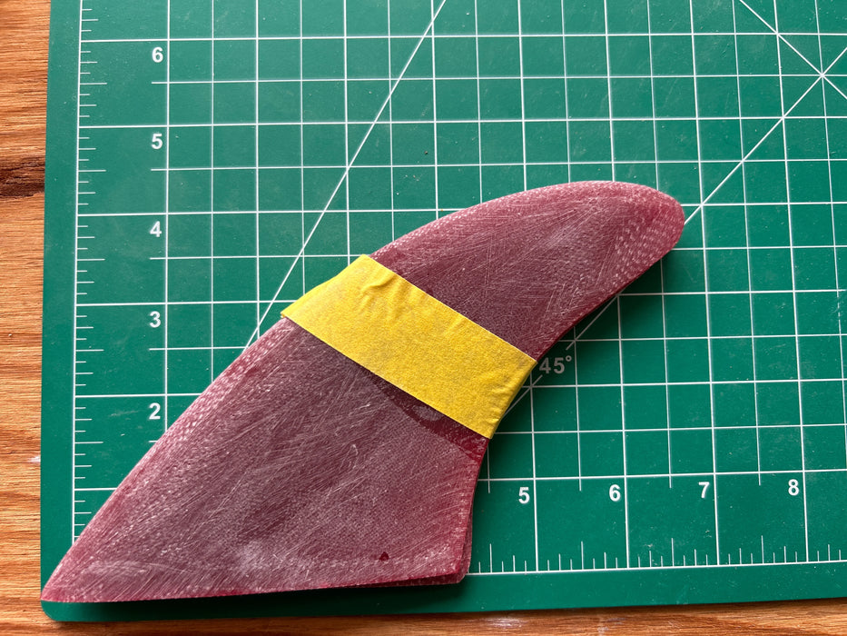 Three red translucent used glass on fins with rake stacked one on top of each other