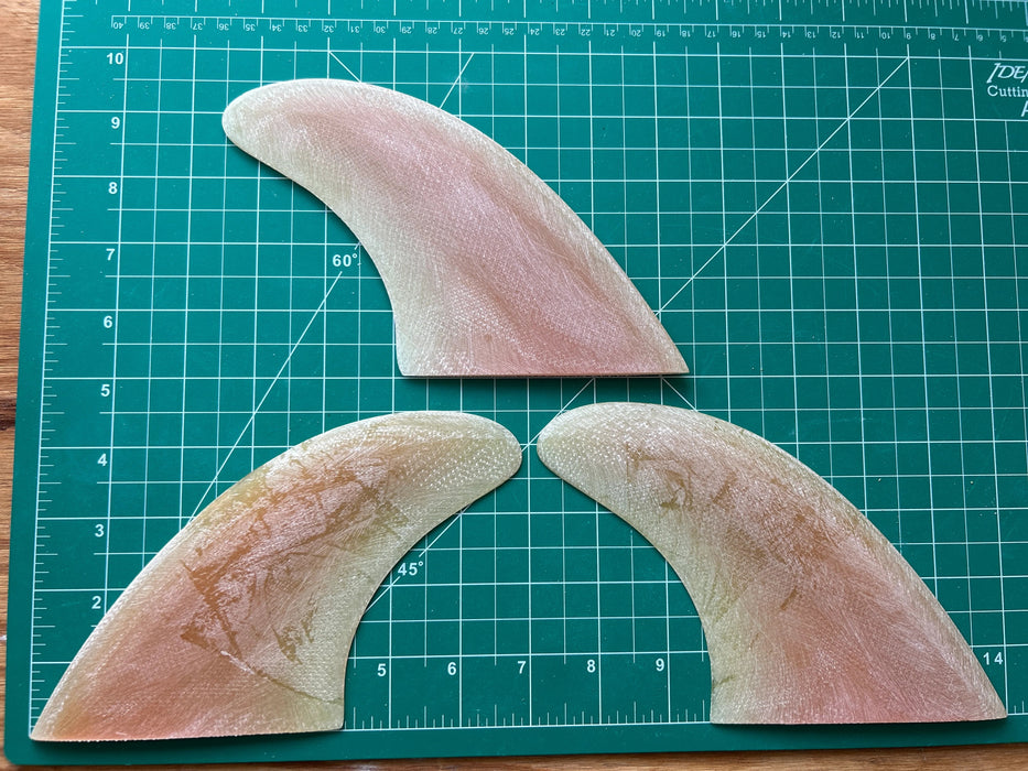 Three peach translucent used glass on fins stacked one on top of each other