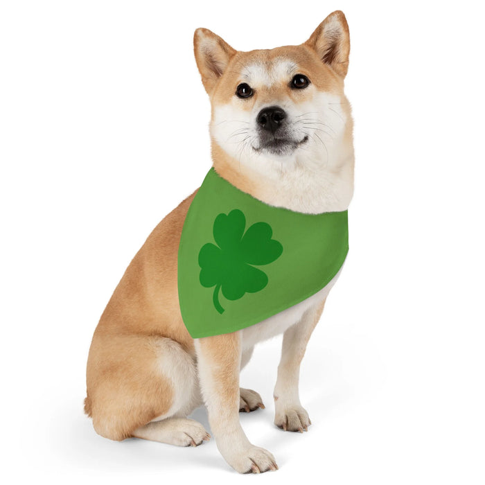 AI seated dog model wearing green bandana with a darker green four leaf clover or shamrock around its neck side view