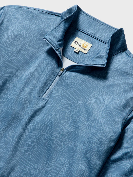 Close-up of a blue quarter-zip pullover with a subtle white line Tapa pattern of waves surfboards and and other Hawaiian elements; Reyn Spooner label inside the collar.