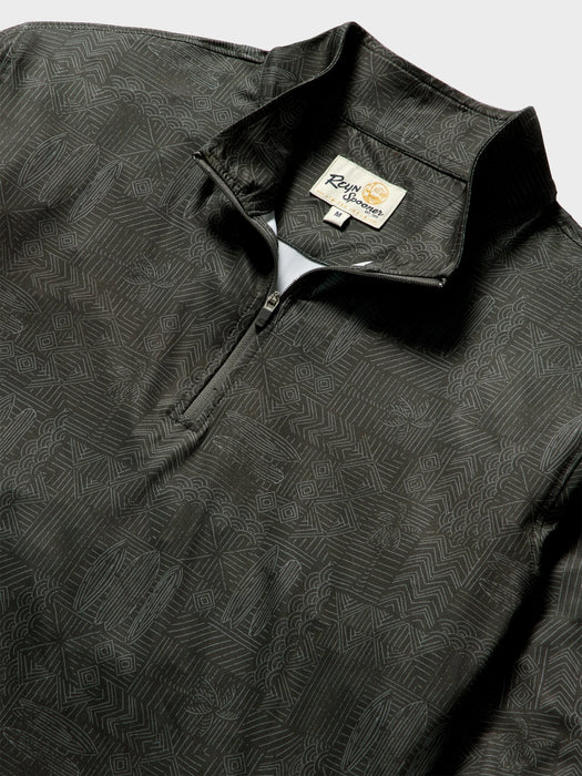 Close-up of a dark charcoal gray quarter-zip pullover with a subtle white line Tapa pattern of waves surfboards and and other Hawaiian elements; Reyn Spooner label inside the collar.