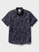 Surfin' Santa Performance Button Front Collared Short Sleeve Charcoal colored Aloha Shirt depicts Santa Surfing Waikiki with Diamondhead in the background front view.