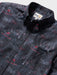 Close up of Surfin' Santa Performance Button Front Collared Short Sleeve Charcoal colored Aloha Shirt depicts Santa Surfing Waikiki with Diamondhead in the background.