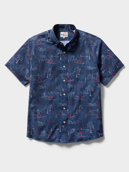 Surfin' Santa Performance Button Front Collared Short Sleeve Navy colored Aloha Shirt depicts Santa Surfing Waikiki with Diamondhead in the background front view.