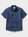 Surfin' Santa Performance Button Front Collared Short Sleeve Navy colored Aloha Shirt depicts Santa Surfing Waikiki with Diamondhead in the background front view.