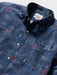 Close up of Surfin' Santa Performance Button Front Collared Short Sleeve Navy colored Aloha Shirt depicts Santa Surfing Waikiki with Diamondhead in the background.