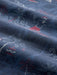A close-up of navy colored fabric with a printed pattern of white line-art of Santa surfing with Diamondhead in the background.