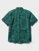 Surfin' Santa Performance Button Front Collared Short Sleeve Pine colored Aloha Shirt depicts Santa Surfing Waikiki with Diamondhead in the background back view.