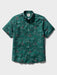 Surfin' Santa Performance Button Front Collared Short Sleeve Pine colored Aloha Shirt depicts Santa Surfing Waikiki with Diamondhead in the background front view.