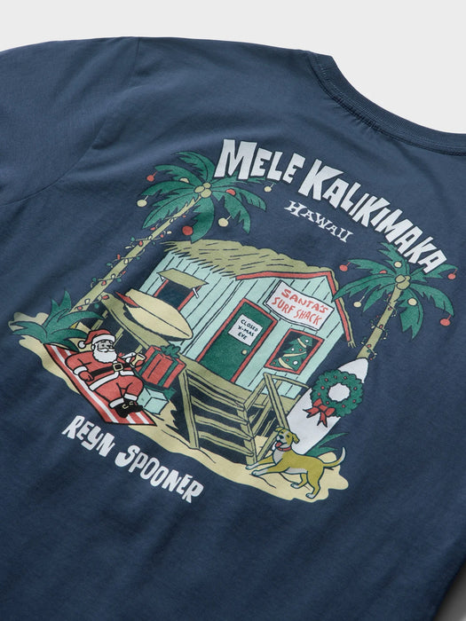 Reyn Spooner Navy Blue T-Shirt back view with Mele Kalikimaka and Santa chillin' at his surf shack with dog, Christmas decorated palms and two surfboards.