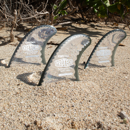 Power Flex is a thruster Pro Teck Fin with a medium core flex on the beach in the sand