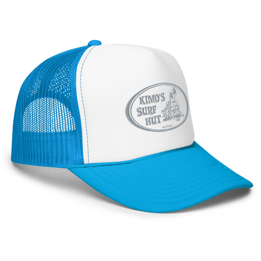 A blue white blue trucker hat with 'Kimo's Surf Hut' embroidered logo in grey and white with surfboards leaning on a hut and palm trees design on the front, right front view.